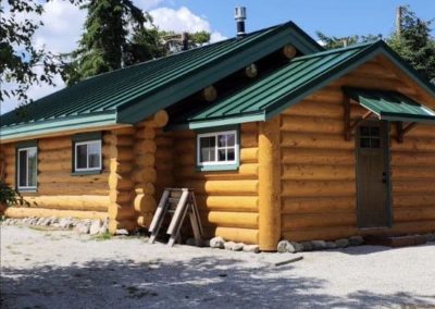 Interior Roofing log home with green metal roof